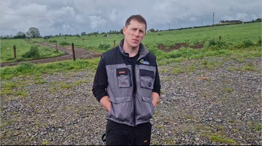 smaXtec testimonial William Condon stands in front of a pasture with Holstein cows.