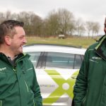 smaXtec employees in front of their car laughing