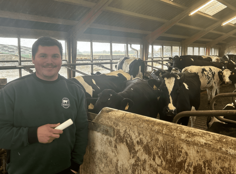 smaXtec testimonial Jesper Juergensenin front of his Holstein cows with a bolus