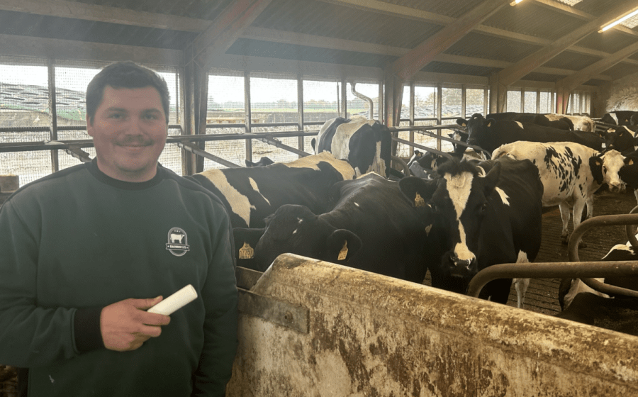smaXtec testimonial Jesper Juergensenin front of his Holstein cows with a bolus